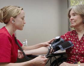A nurse measuring a patient's blood pressure.